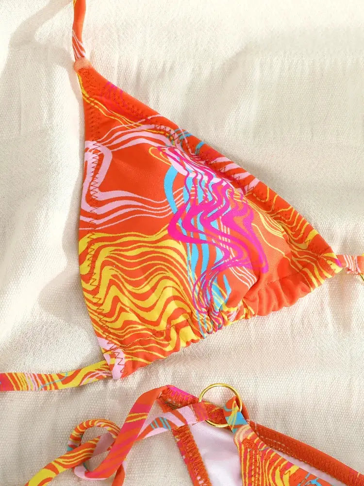 Triangle bikini top and matching bottom in bright orange multicolor zebra print with string ties