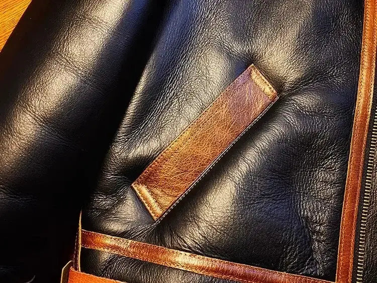 Men's black leather shearling jacket with brown leather trim and strap details