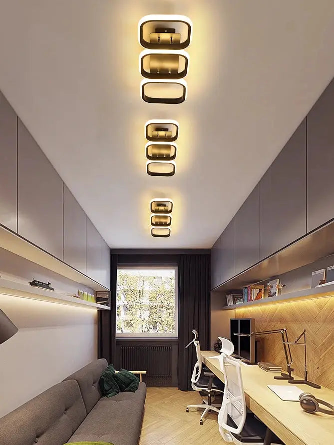 LED ceiling lights with modern square-ring design along hallway ceiling, warm white glow.