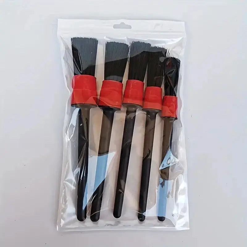 Car detailing brush set; five black-handled brushes with red ferrules in a clear plastic package.