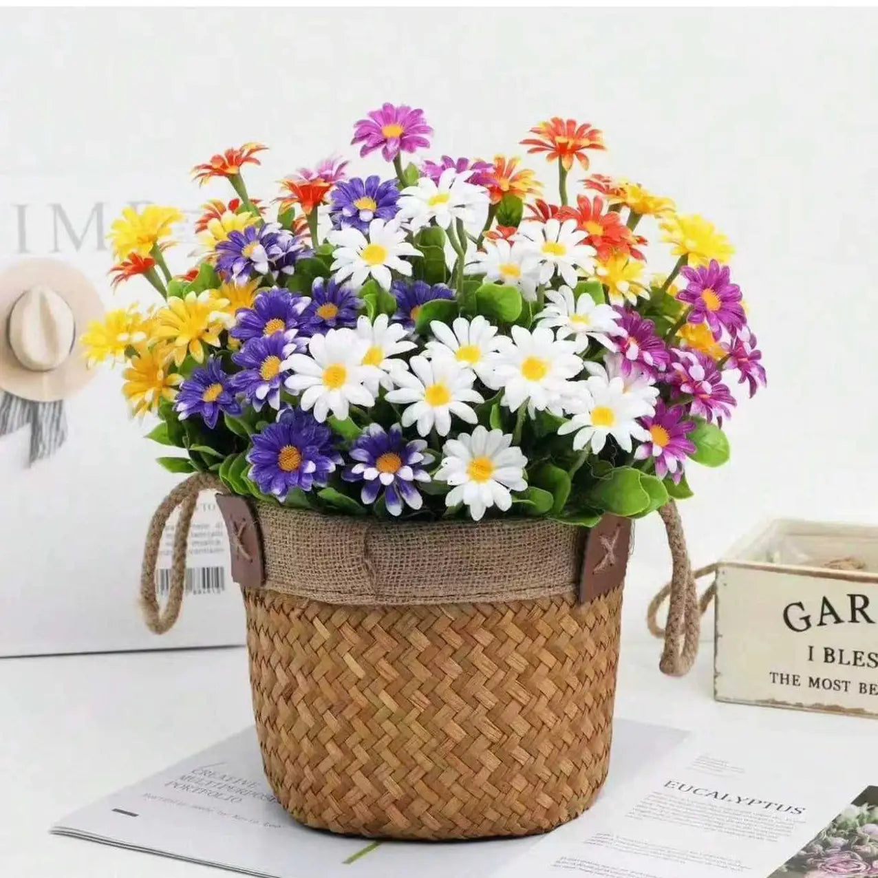 Artificial daisy bouquet in a woven wicker basket with burlap trim, multicolor silk flowers for home decor.