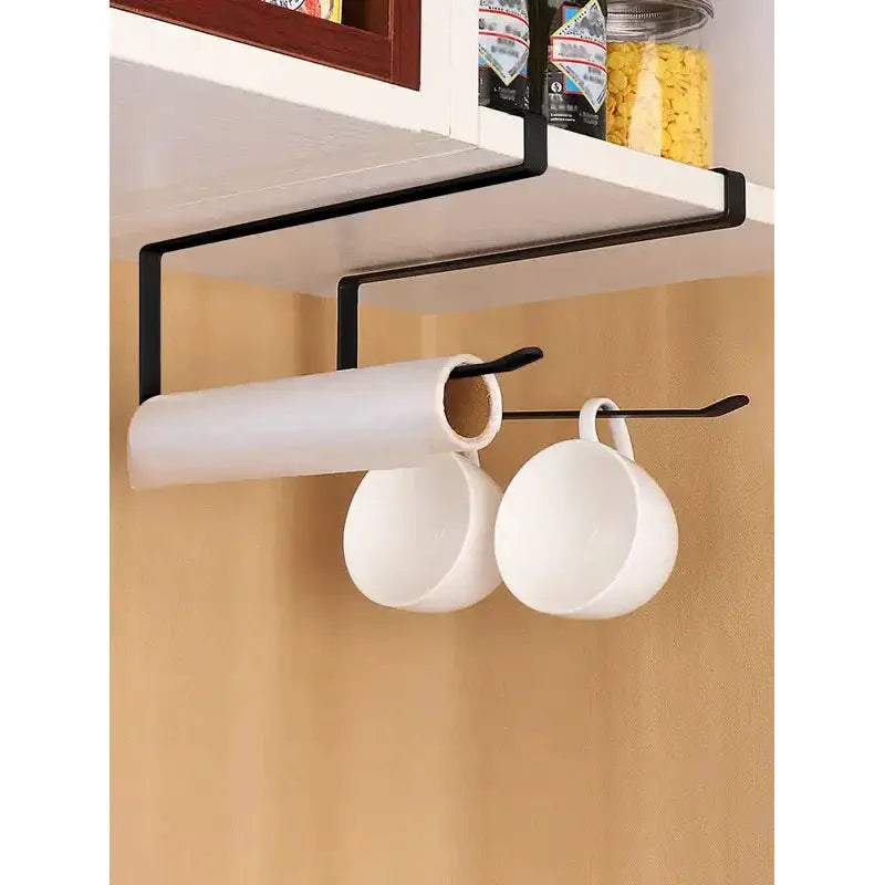 Black metal paper towel holder with a wall-mounted hanging shelf, holding a roll and two white mugs