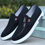 Men's black canvas slip-on sneakers with white soles, breathable casual footwear (2 shown)