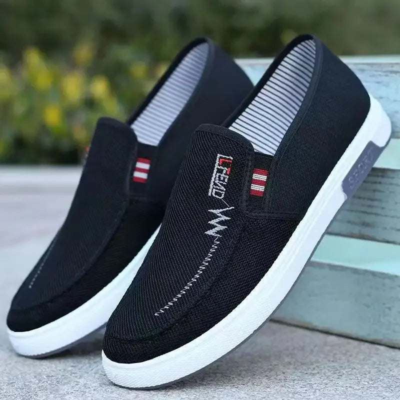Men's black canvas slip-on sneakers with white soles, breathable casual footwear (2 shown)