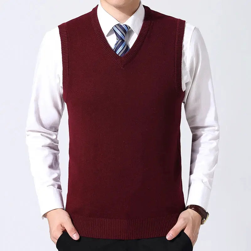 Men's burgundy V-neck sweater vest over white dress shirt.