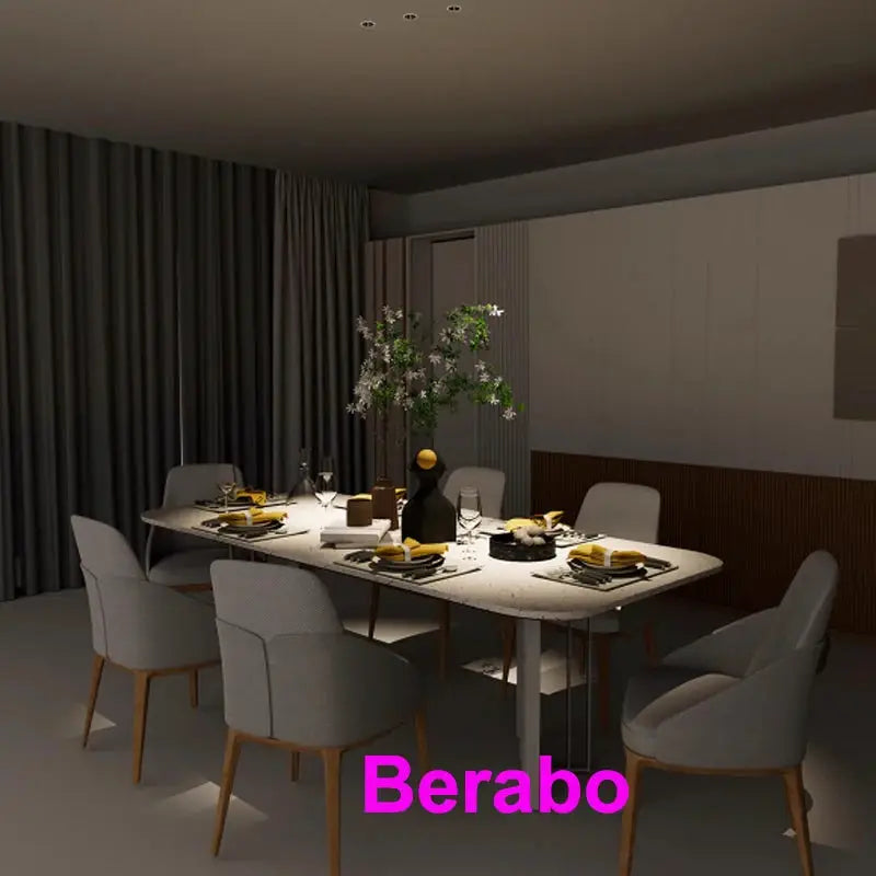 Recessed LED downlight by Berabo; modern dining room with long table and upholstered chairs.