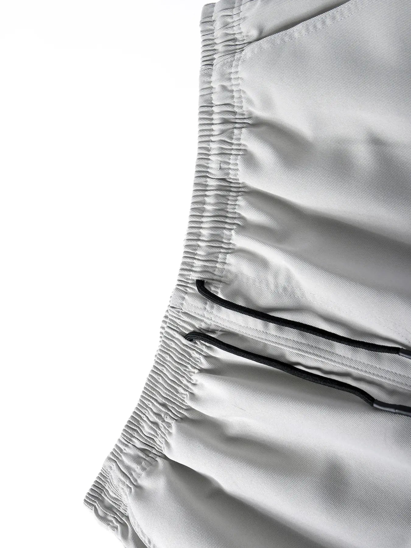 Men's light gray jogger pants with elastic waistband and black drawstrings