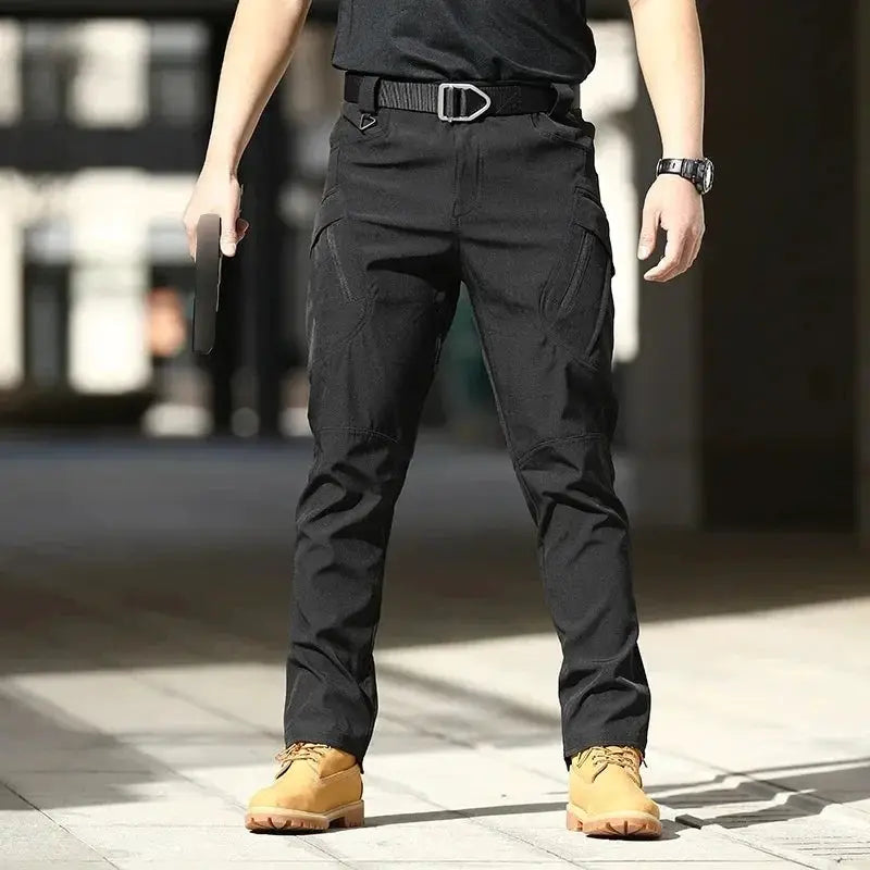 Men's black waterproof cargo pants with multiple pockets and a tactical belt