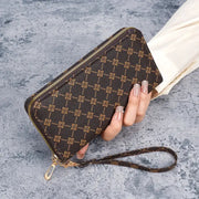 Wallet clutch by Simples Market, brown monogram print, large-capacity with gold zipper and wrist strap.
