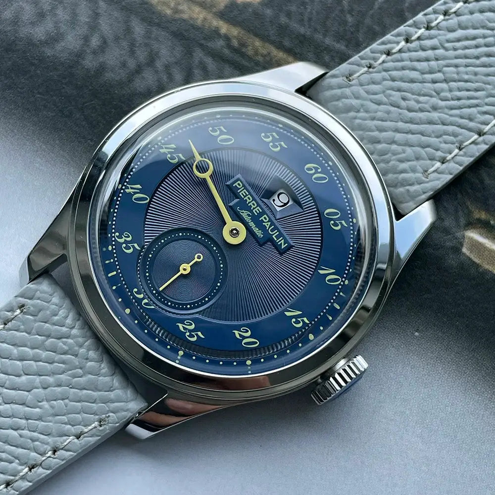 Pierre Paulin Jumping Hour men’s watch with blue dial, gold hands, date window, small seconds, light blue leather strap