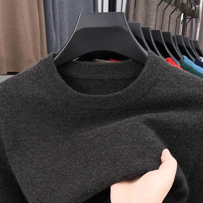 Men's black knitted sweater with round neck and long sleeve on display with other colors