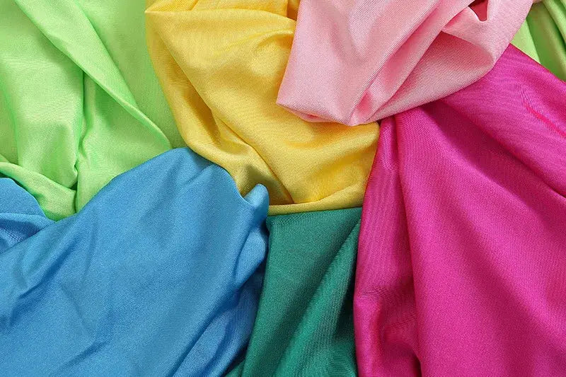 Colorful fabric swatches in lime green, blue, teal, yellow, pink, and magenta.