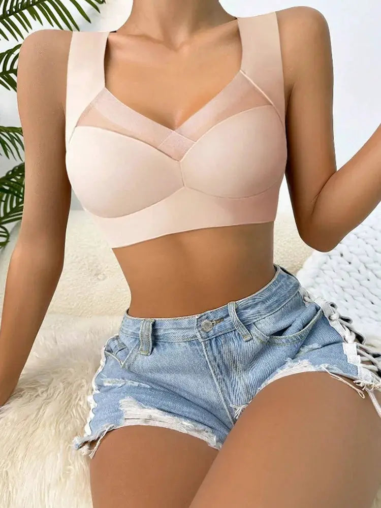 Women’s nude-pink seamless lace bralette, wireless support, shown with denim shorts.