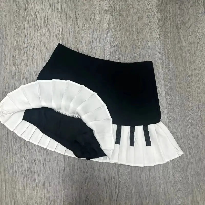 Women’s black and white spliced mini skirt with white pleated hem detailing, Y2K Harajuku style
