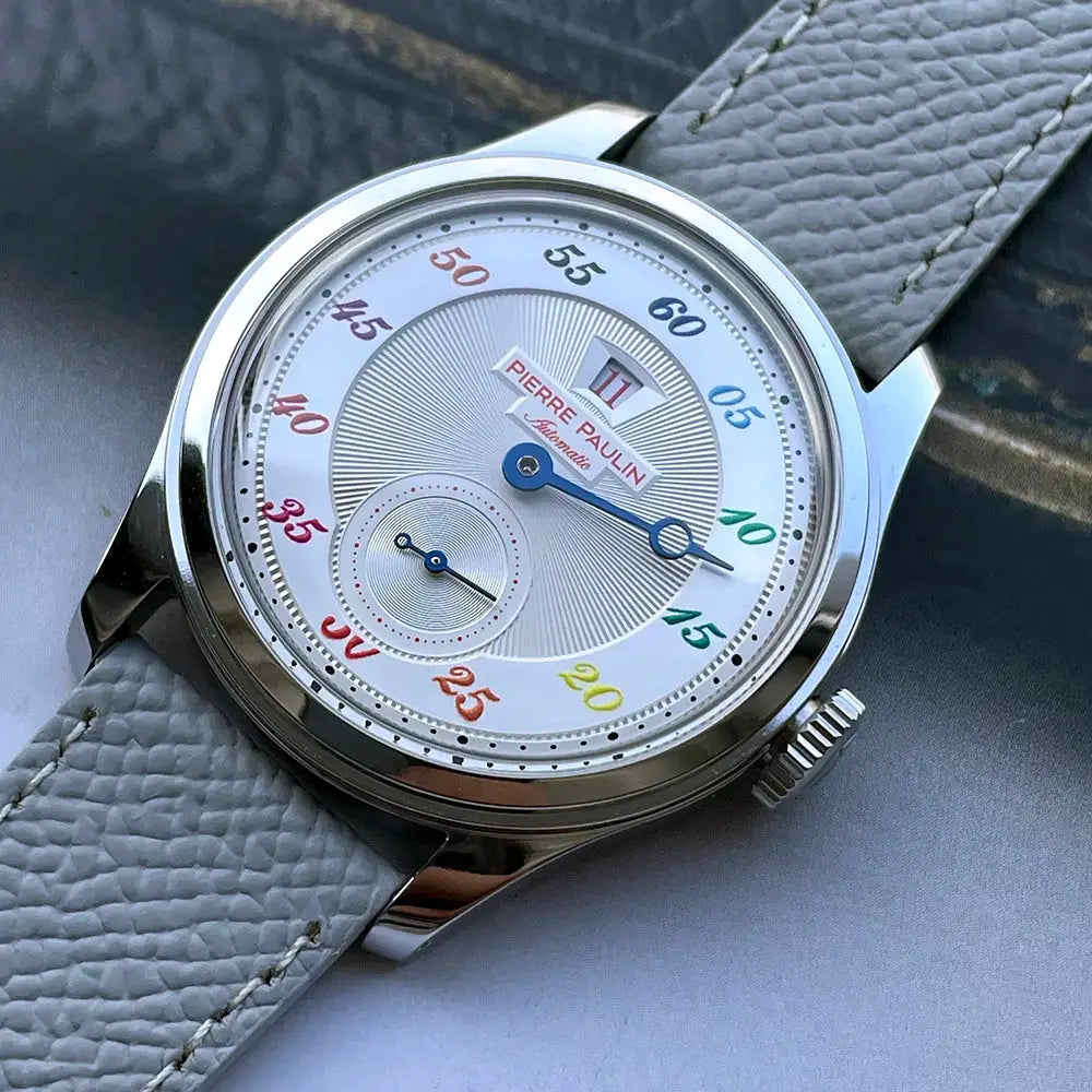 Pierre Paulin Jumping Hour men's watch, white dial with multicolor numerals, stainless steel case, gray leather strap.