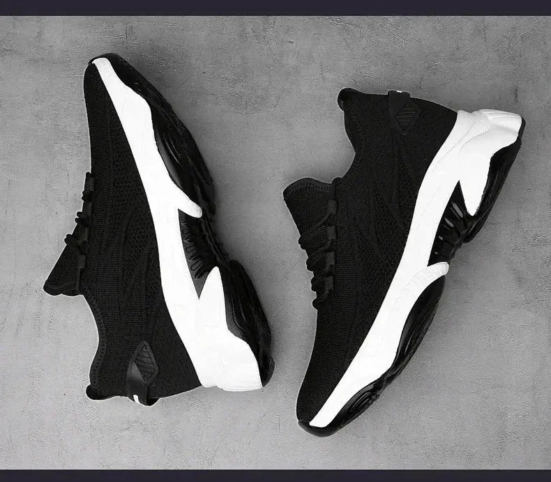 Pair of black height-increasing sneakers with white soles and breathable mesh upper.