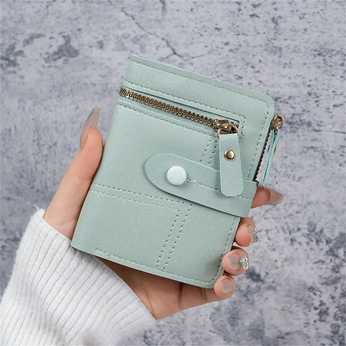 Light green women's wallet with snap strap and zip pocket, thin card-clip style