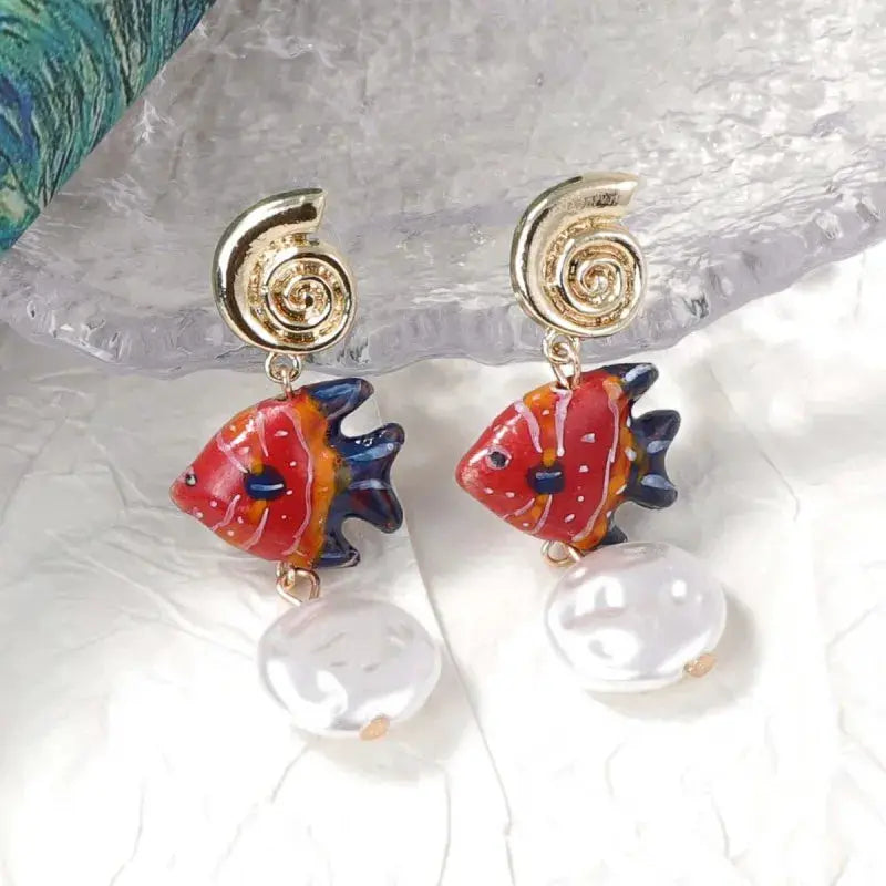 Octopus earrings pair with glass orange octopus charms and white pearl drops, gold spiral studs, Simples Market