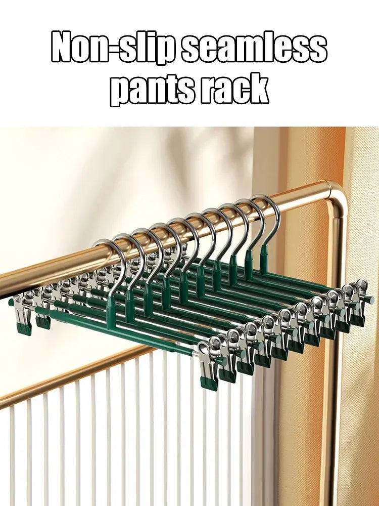 Wardrobe drying rack with green clip pants hangers on a stainless steel frame