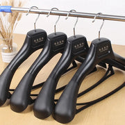 5pcs wide-shoulder black plastic clothing hangers with metal hooks for wardrobe organization.