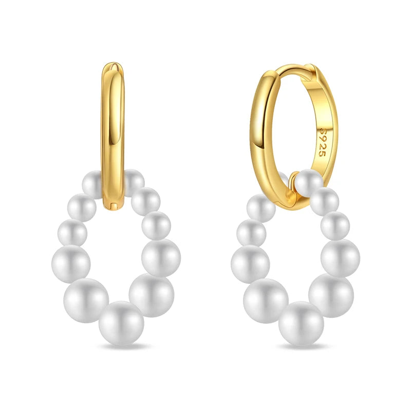 Gold-tone pearl hoop earrings, pair featuring white pearl beads on hinged hoops.