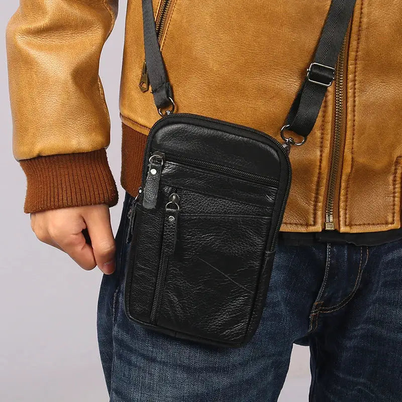Men's black leather waist bag with multiple zip pockets and an adjustable crossbody strap
