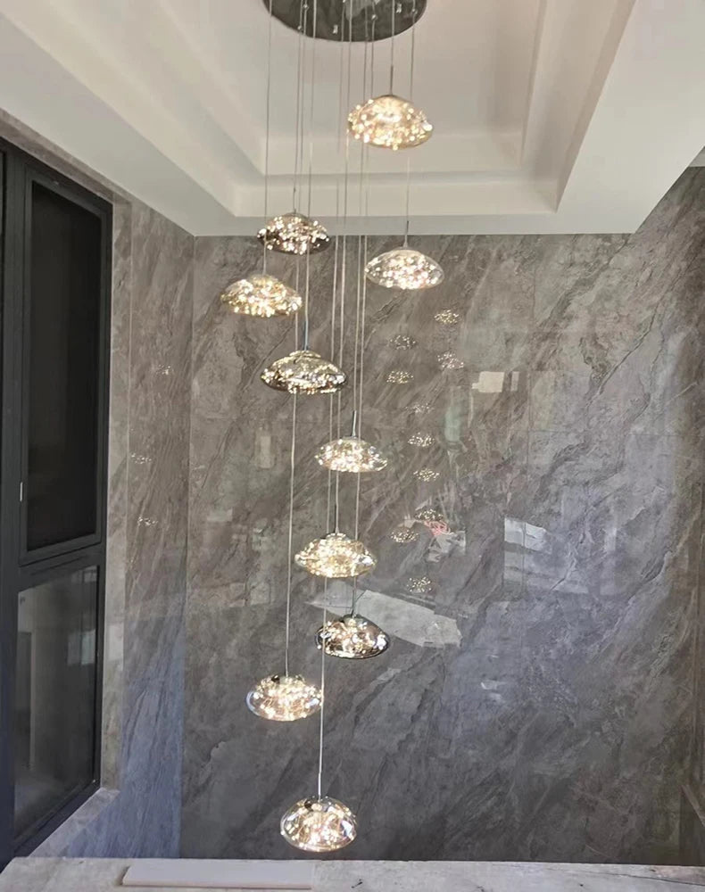 Simples Market modern dining room pendant lights; nine clear glass dome pendants on hanging cables