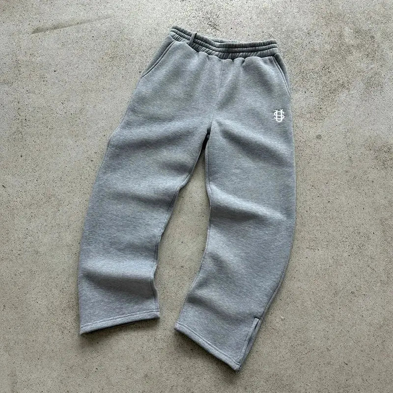Gray Simples Market sweatpants with elastic waistband and small white logo on the thigh, solid casual wear