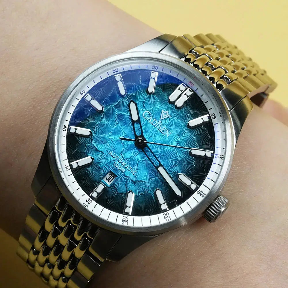 CADISEN men's automatic wristwatch with blue textured dial, silver case and gold-tone bracelet, date window