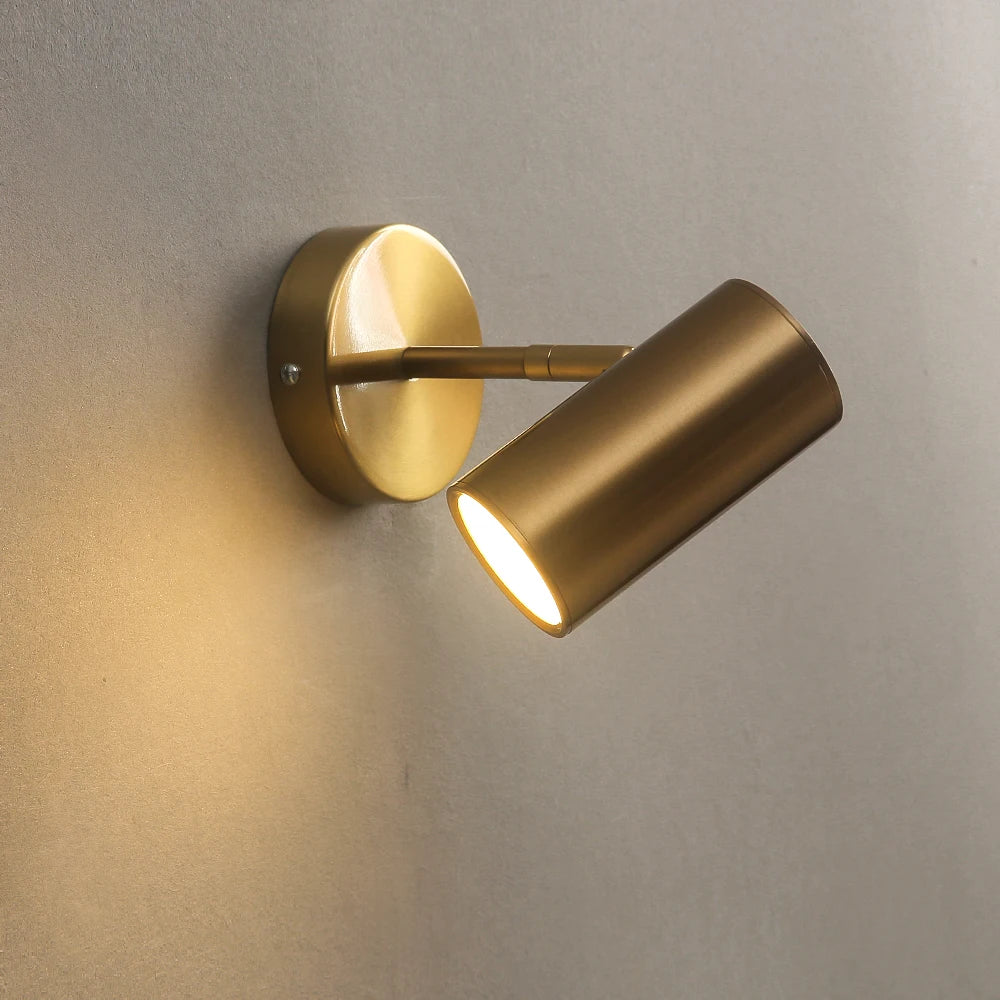 Nordic modern brass wall lamp with adjustable cylindrical LED head on round wall mount