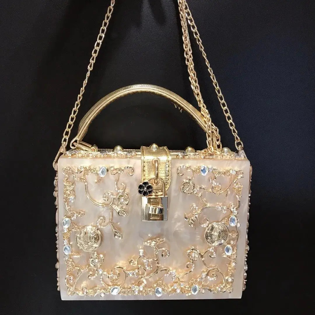 Crystal-embellished evening bag in pale pink mother-of-pearl with gold-tone filigree and chain
