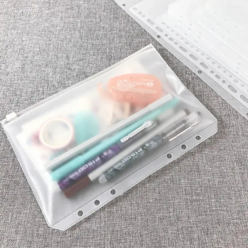 Clear waterproof zipper binder pouch for A5–A7 binders with assorted stationery items inside
