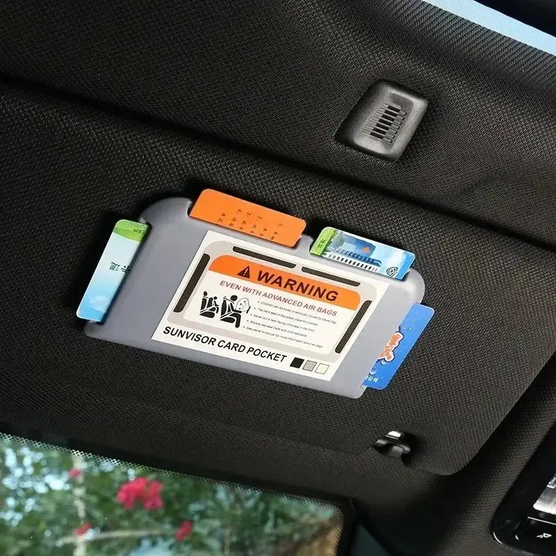 Car sun visor card pocket organizer by Simples Market; gray plastic holder with cards inserted.