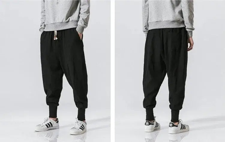 Men's cotton-linen harem pants in black with drop-crotch, cuffed ankles, streetwear joggers, front and back views