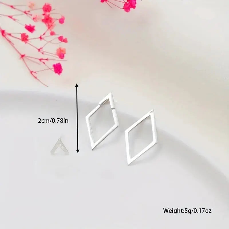 Square geometric stud earrings by Simples Market; two hollow diamond frames with detachable triangles in silver