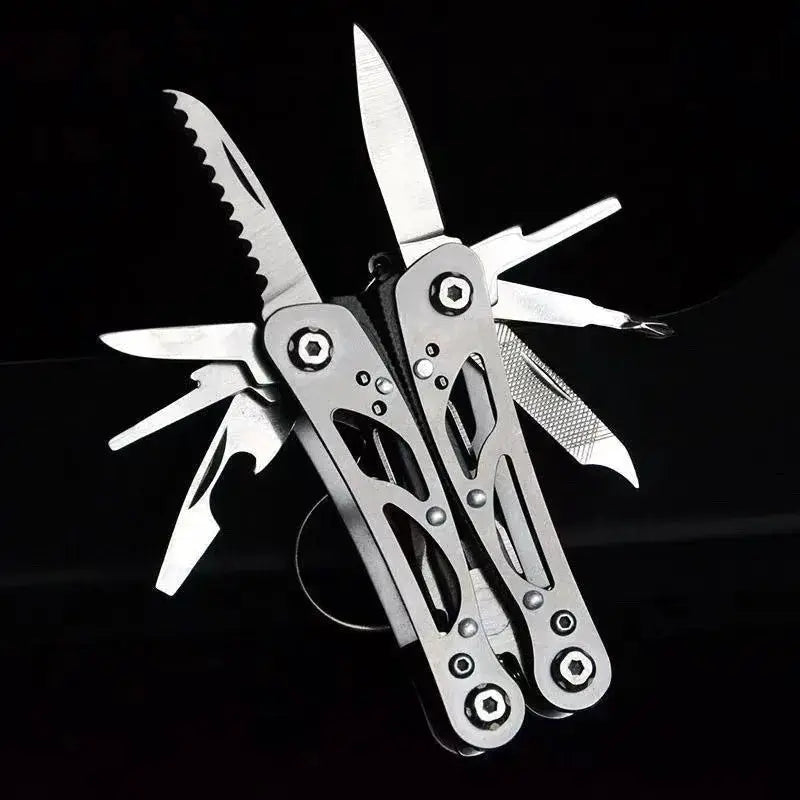 Simples Market folding multi-tool with pliers in metallic silver; outdoor survival knife, serrated blade, compact.