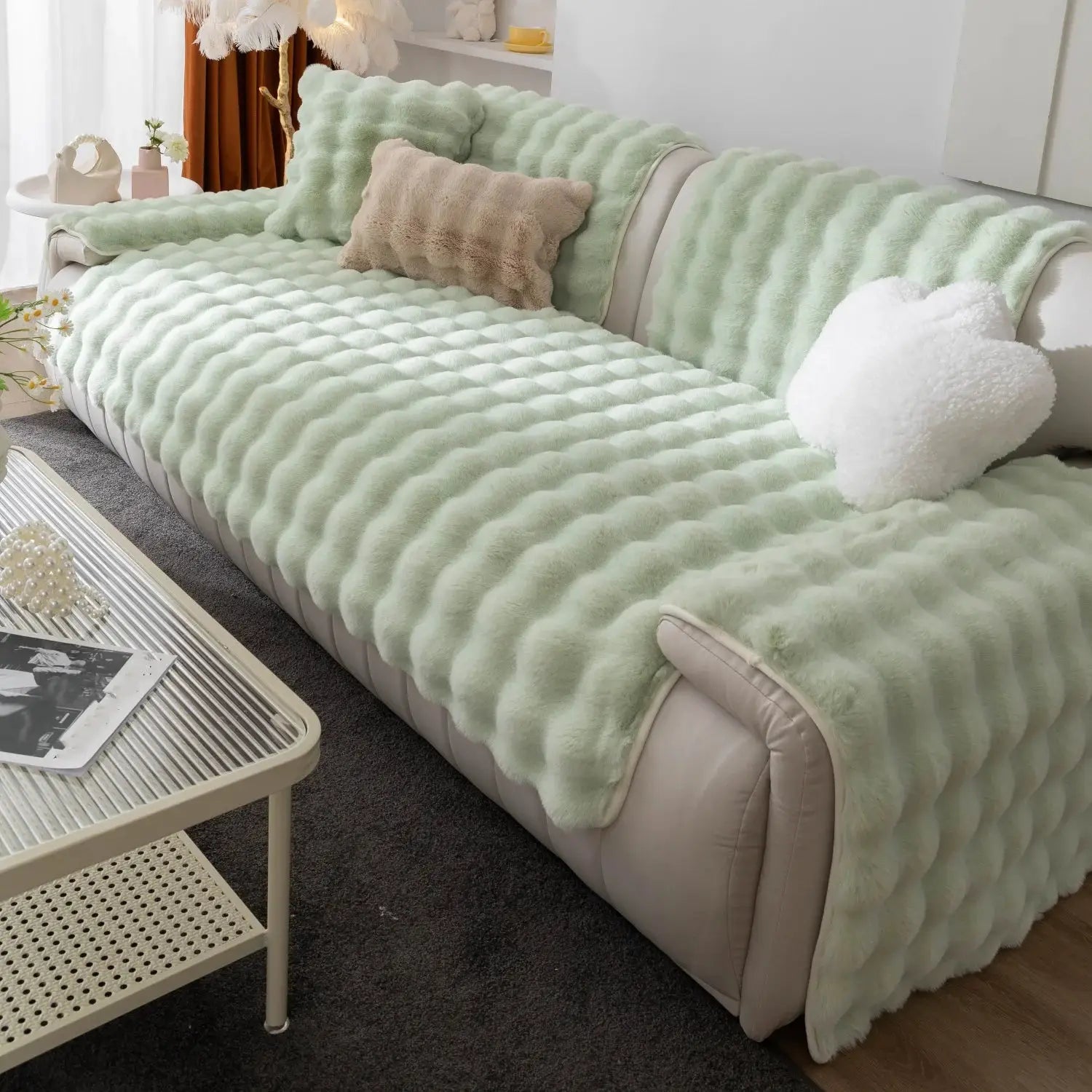 Thick mint-green imitation rabbit fur sofa slipcover with matching cushions on a beige sofa