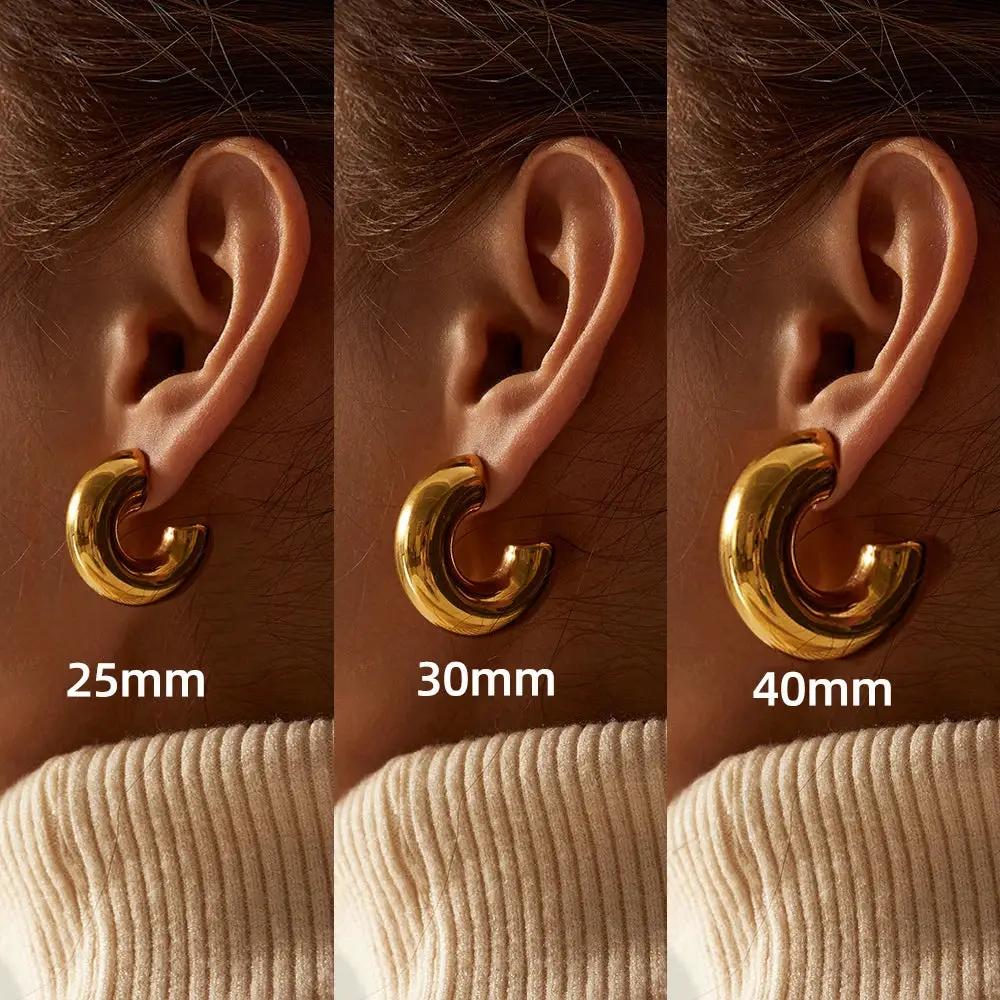 Chunky hoop earrings by Simples Market; gold-plated stainless steel C-shaped hoops in 25mm, 30mm, and 40mm sizes