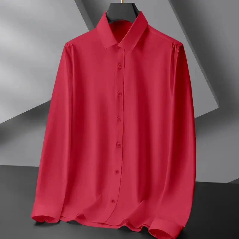 Men's red solid long-sleeve dress shirt with wrinkle-resistant fabric, hanging on display.