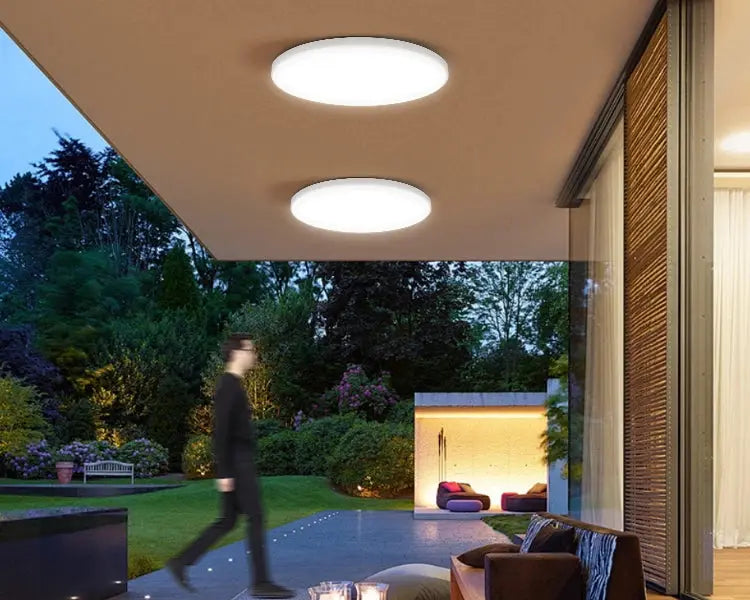 Radar ceiling light with motion sensor; two round white LED fixtures mounted on an outdoor patio ceiling by Simples Market.