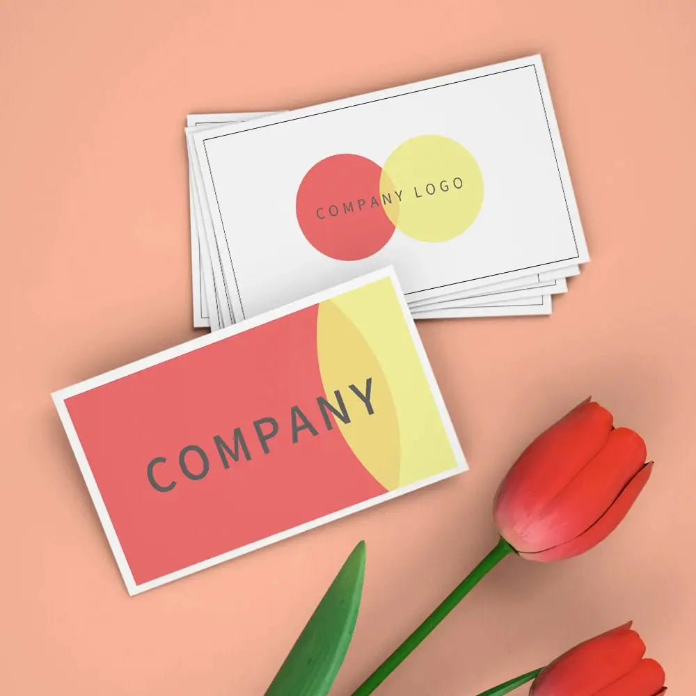 Custom business cards and postcards with a company logo, pink and white designs.