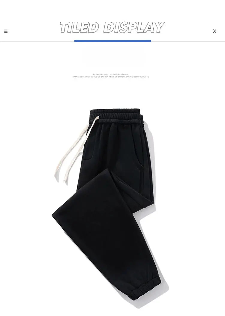 Men's black jogger sweatpants with white drawstrings, elastic waistband, pockets, and cuffed ankles.