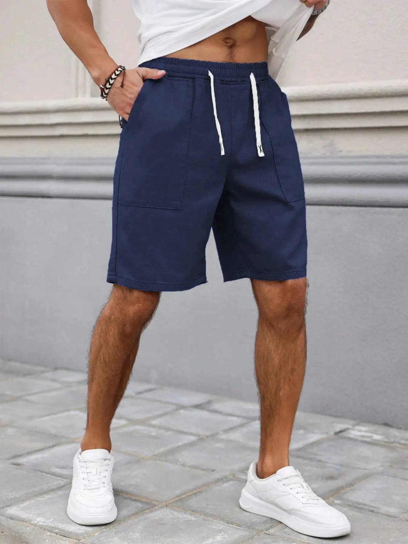 Men's navy blue shorts with white drawstring, mid-length casual style and front patch pockets