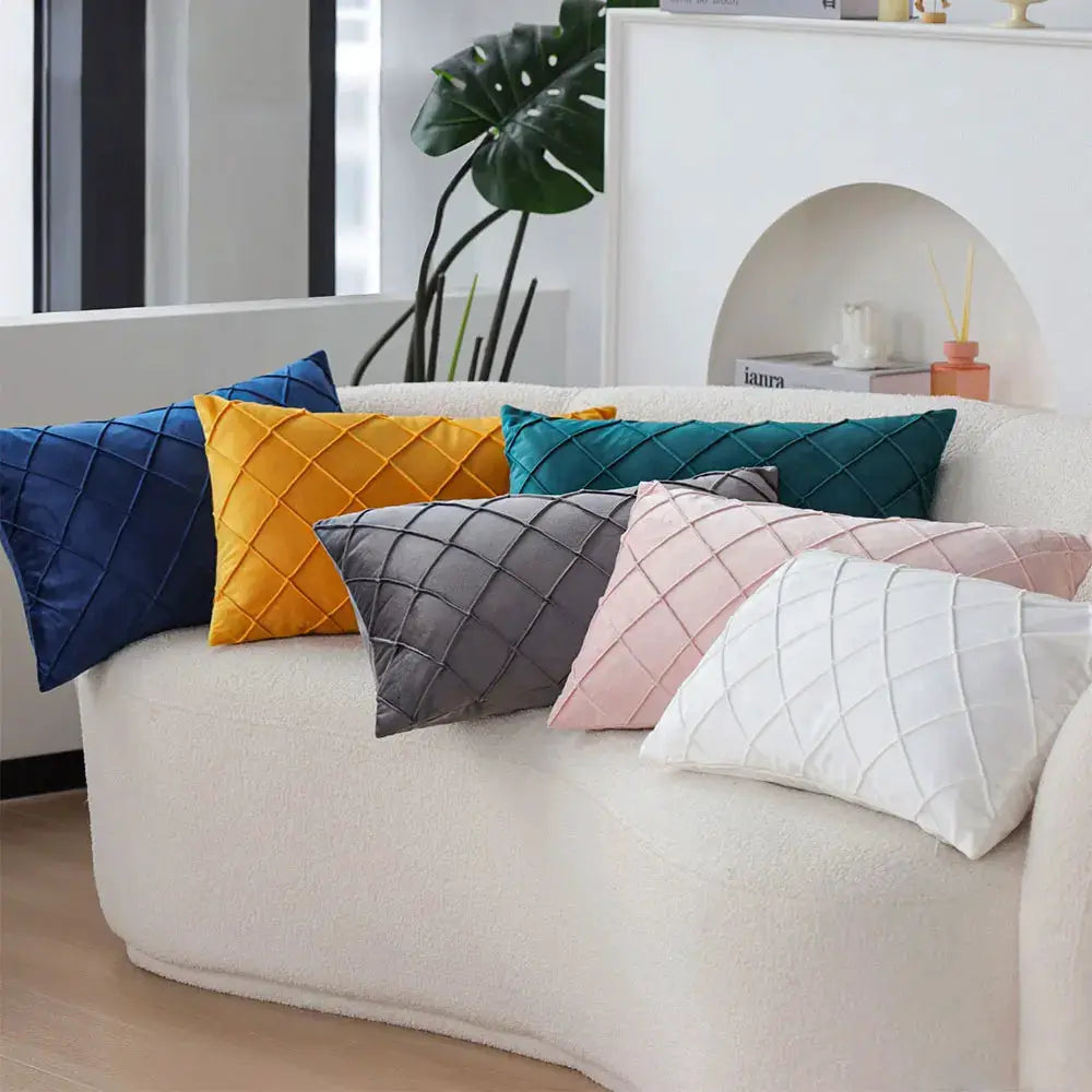 Simples Market six 30x50 cm quilted rectangular pillow covers in navy, orange, teal, gray, pink and white on a cream sofa