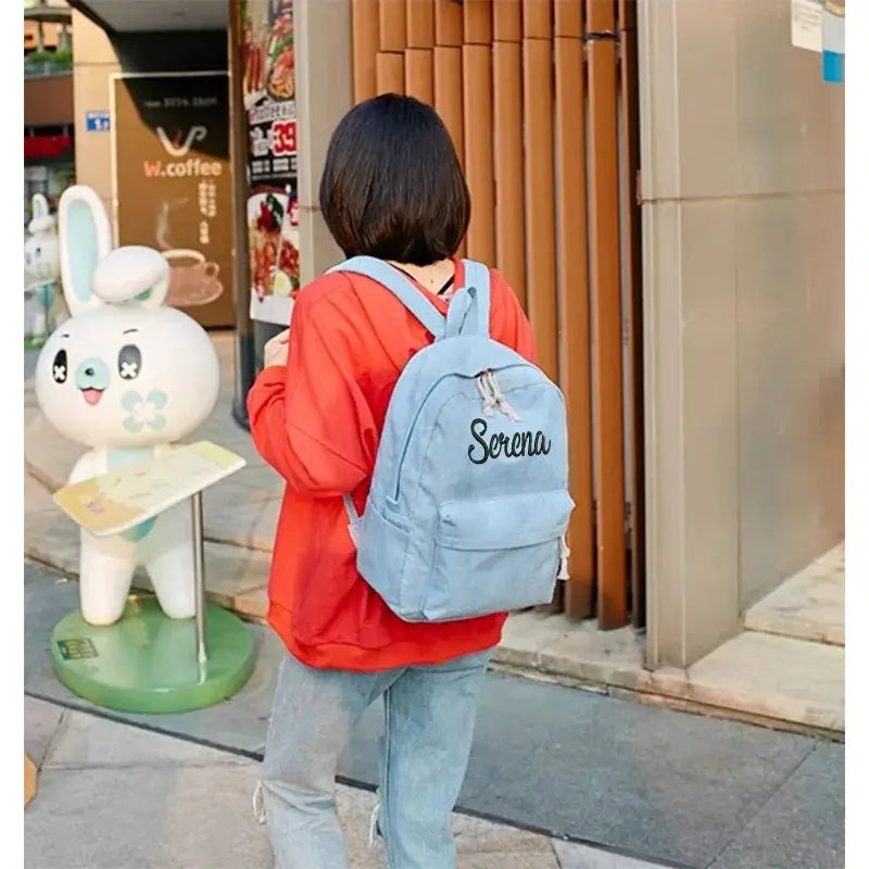 Personalized light-blue corduroy kids backpack embroidered with the name Serena.