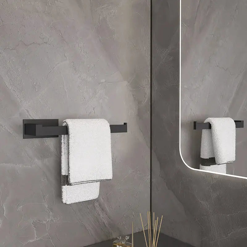 Simples Market black metal self-sticking bathroom hardware set with towel rail and towel.