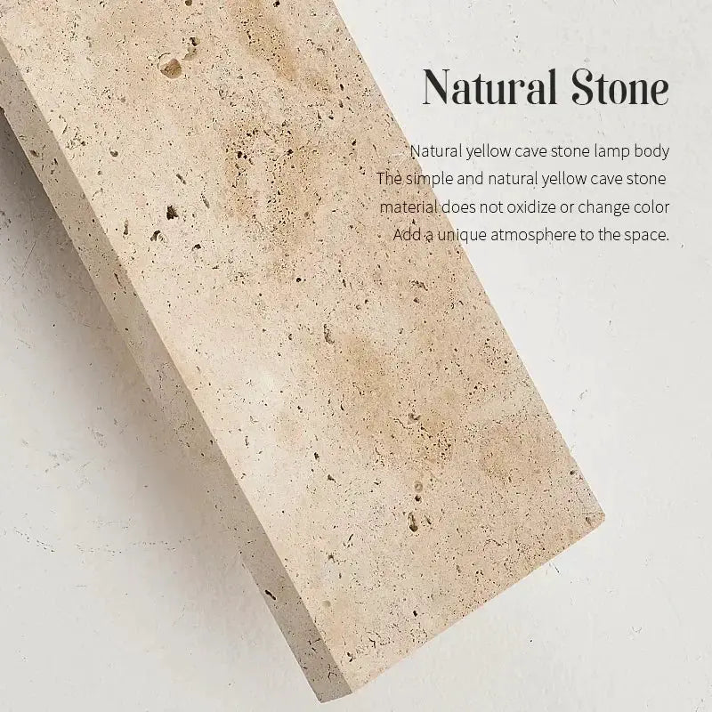 Natural stone outdoor wall lamp in beige speckled texture, close-up shot