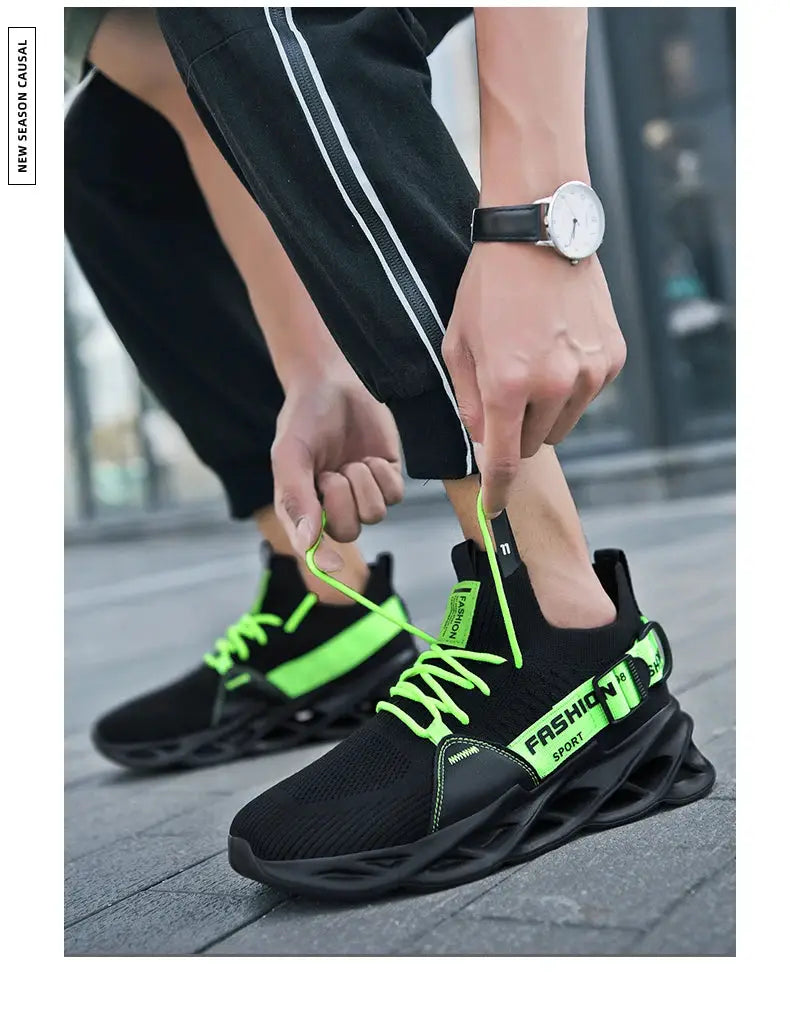 Pair of men’s mesh breathable sneakers with black upper, neon lime laces and thick sculpted sole.