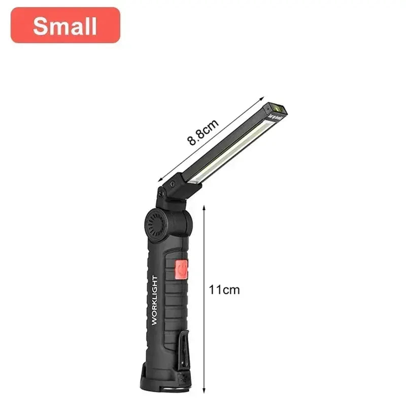 Portable black COB LED work light with adjustable head and red power button, 11 cm tall.
