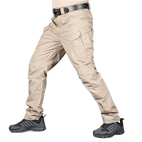 Men's beige tactical cargo pants with multiple pockets, rugged hiking/working trousers